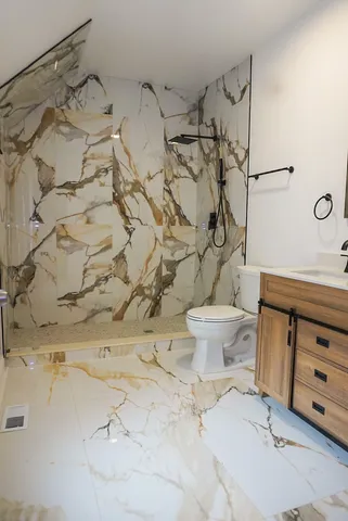 a bathroom with a sink toilet and shower