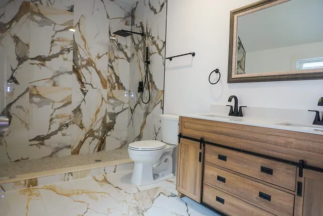 a bathroom with a toilet sink and mirror