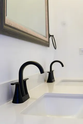 a close view of a sink a faucet and a rug