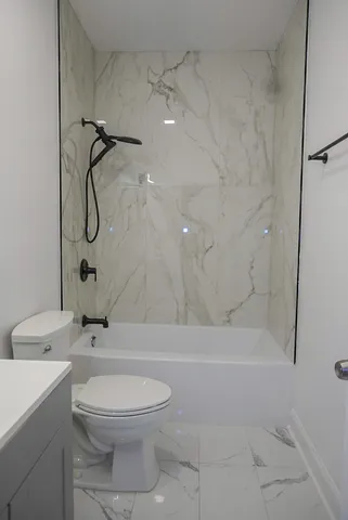 a bathroom with a toilet sink and shower