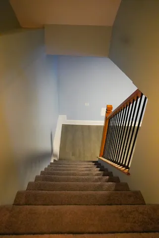 a view of staircase with wooden floor