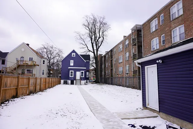 a front view of a house with a snow in the yard