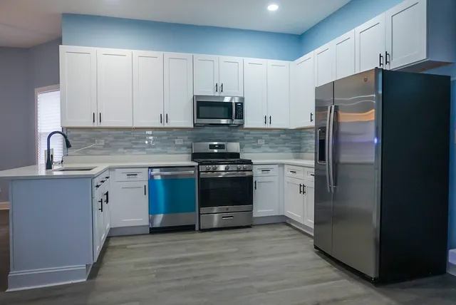 a kitchen with a refrigerator stove and sink