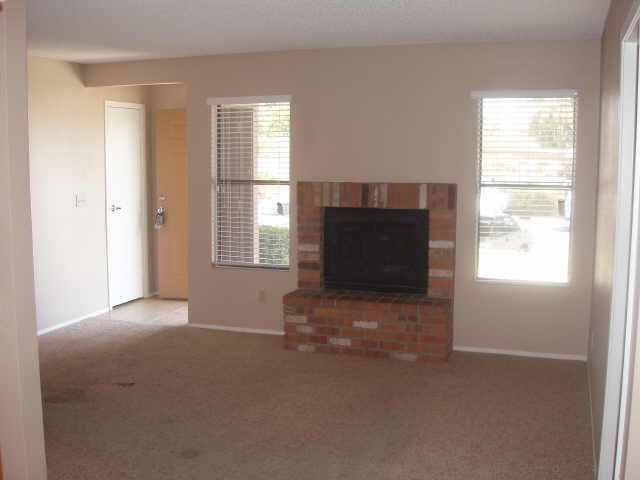 3511 East Baseline Road, Unit 1003 Phoenix, AZ 85042 - Photo 3 of 4 a view of a livingroom with an empty space and a window