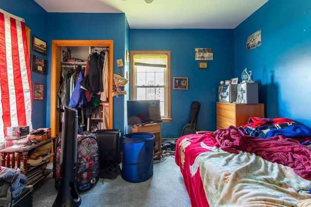 a bedroom with a bed and closet
