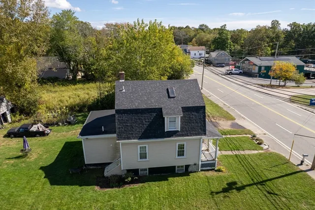 an aerial view of a house with yard swimming pool and outdoor seating