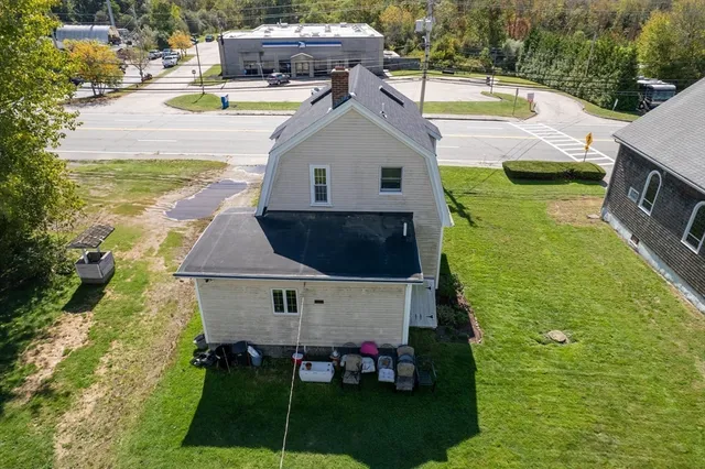 a aerial view of a house with swimming pool and next to a yard