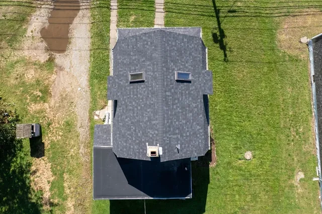 a aerial view of a house with a yard