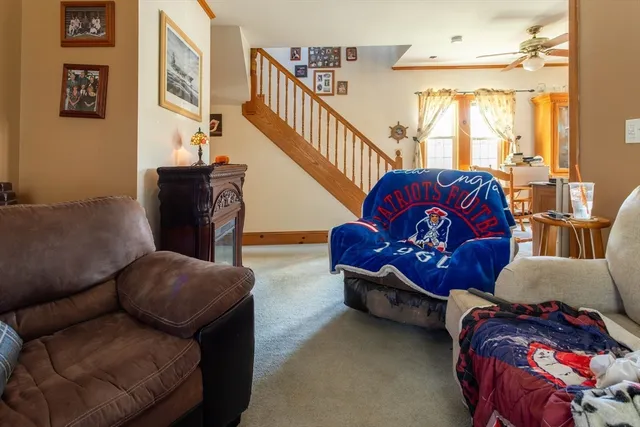 a living room with furniture fireplace and windows