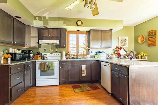 a kitchen with stainless steel appliances granite countertop a sink and cabinets
