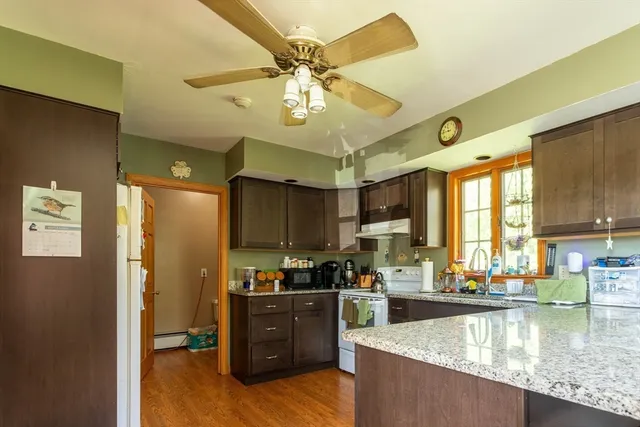 a kitchen with stainless steel appliances granite countertop a refrigerator a stove and a sink