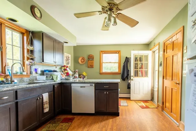a kitchen with a sink appliances and cabinets