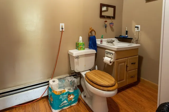 a bathroom with a toilet a sink and a mirror