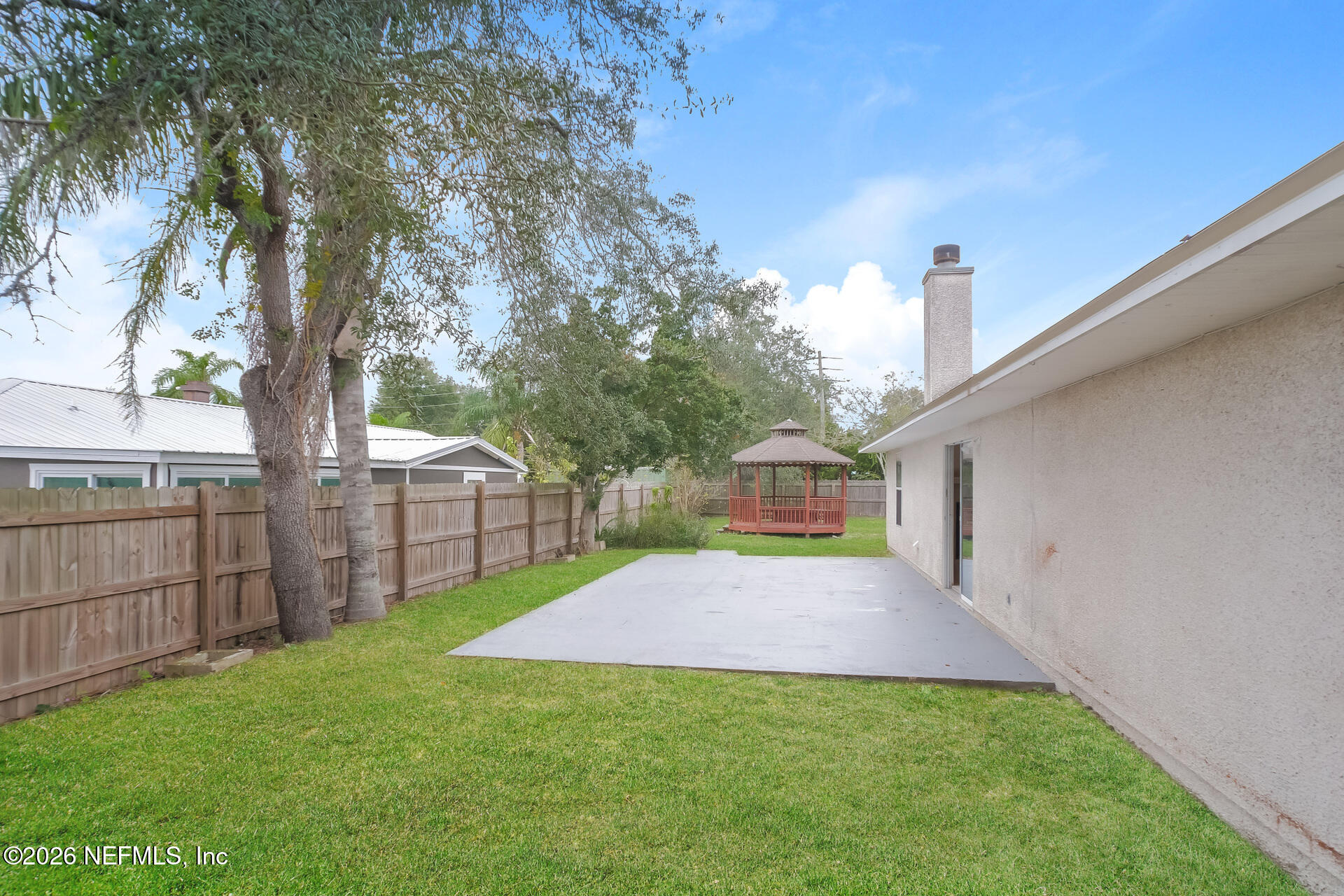 304 Segovia Road St. Augustine, FL 32086 - Photo 14 of 15 a view of a yard in front of a house with wooden fence