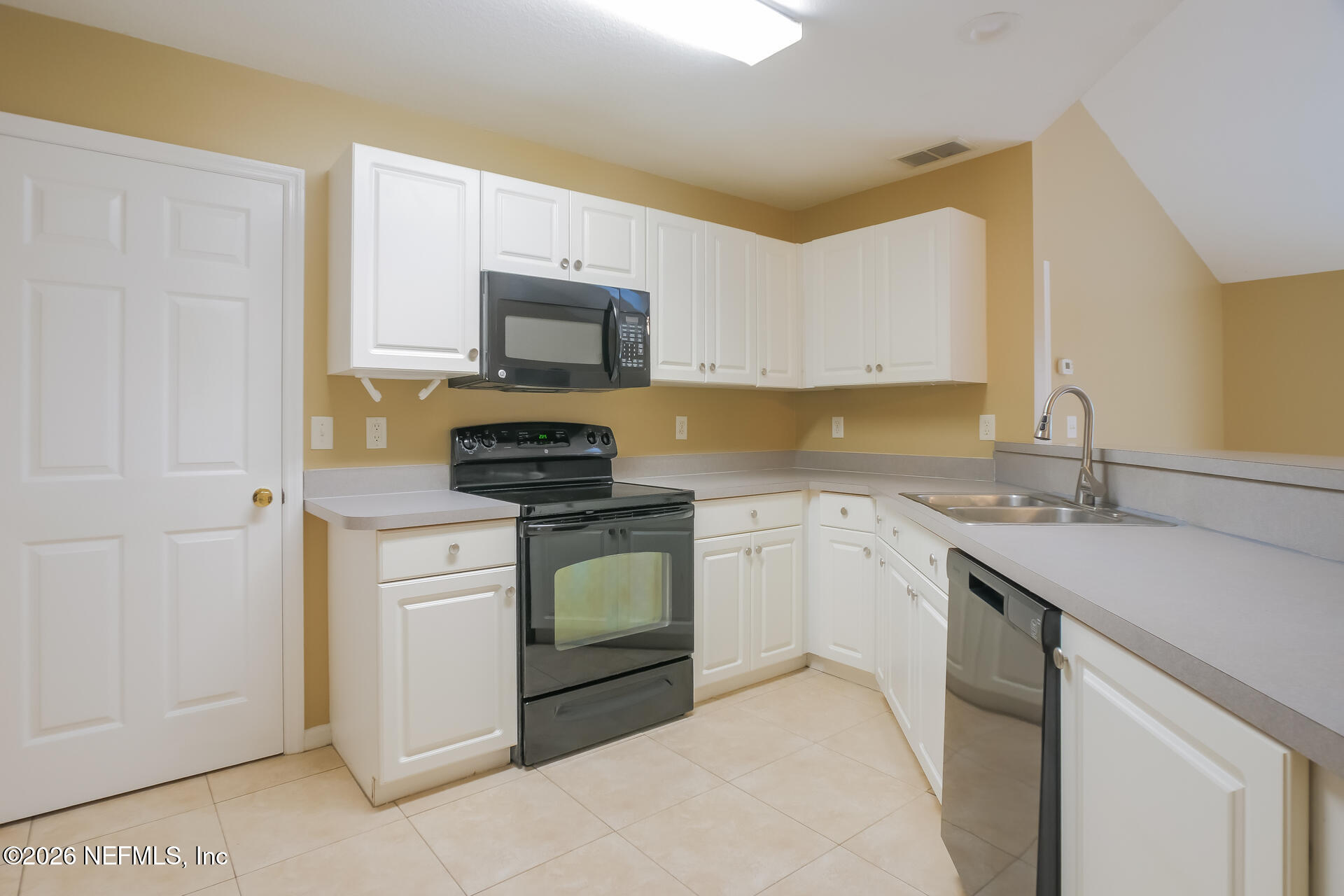 304 Segovia Road St. Augustine, FL 32086 - Photo 6 of 15 a kitchen with a sink stove and microwave