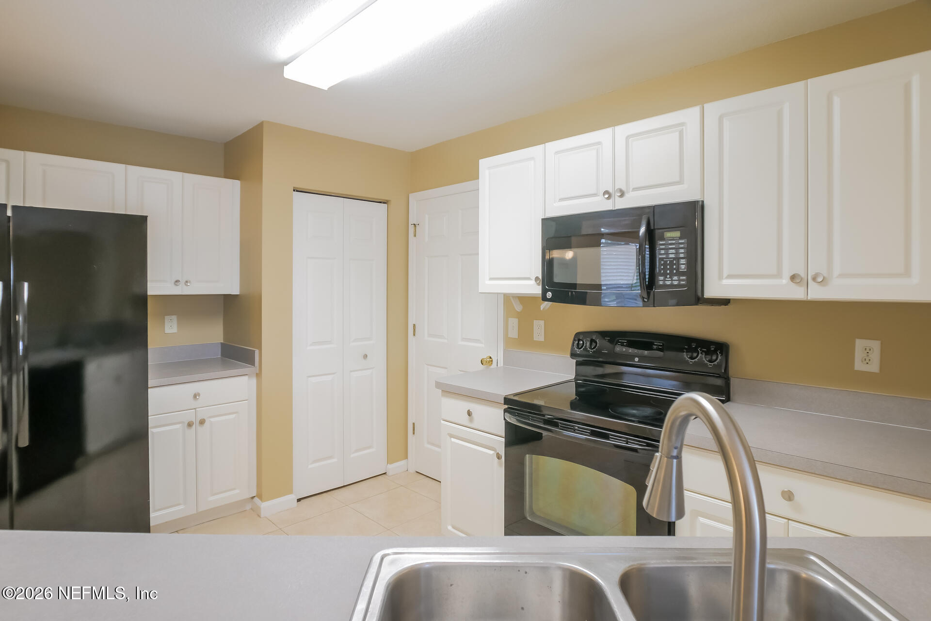 304 Segovia Road St. Augustine, FL 32086 - Photo 7 of 15 a kitchen with stainless steel appliances a stove a microwave and a refrigerator