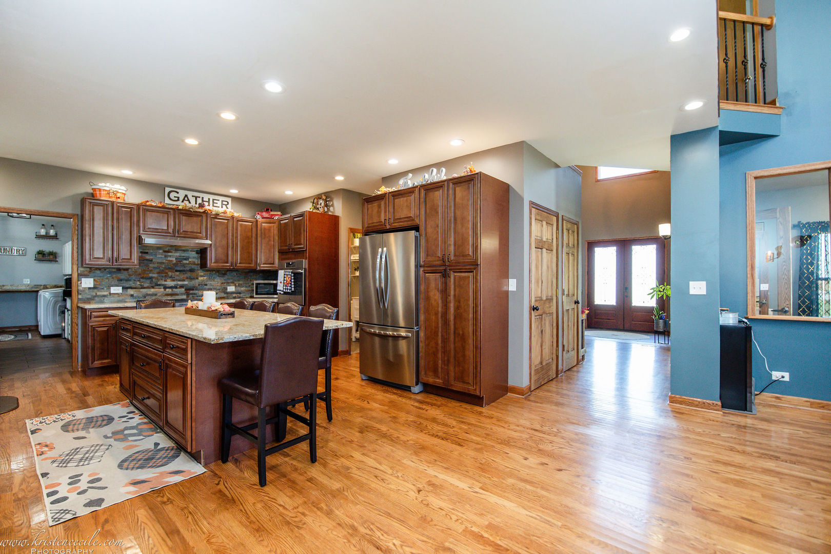27243 South 88th Avenue Monee, IL 60449 - Photo 21 of 59 a kitchen with stainless steel appliances kitchen island granite countertop a stove and a refrigerator