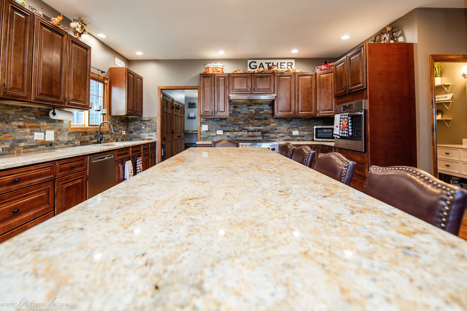 27243 South 88th Avenue Monee, IL 60449 - Photo 24 of 59 a large kitchen with kitchen island granite countertop a sink counter space stainless steel appliances and cabinets