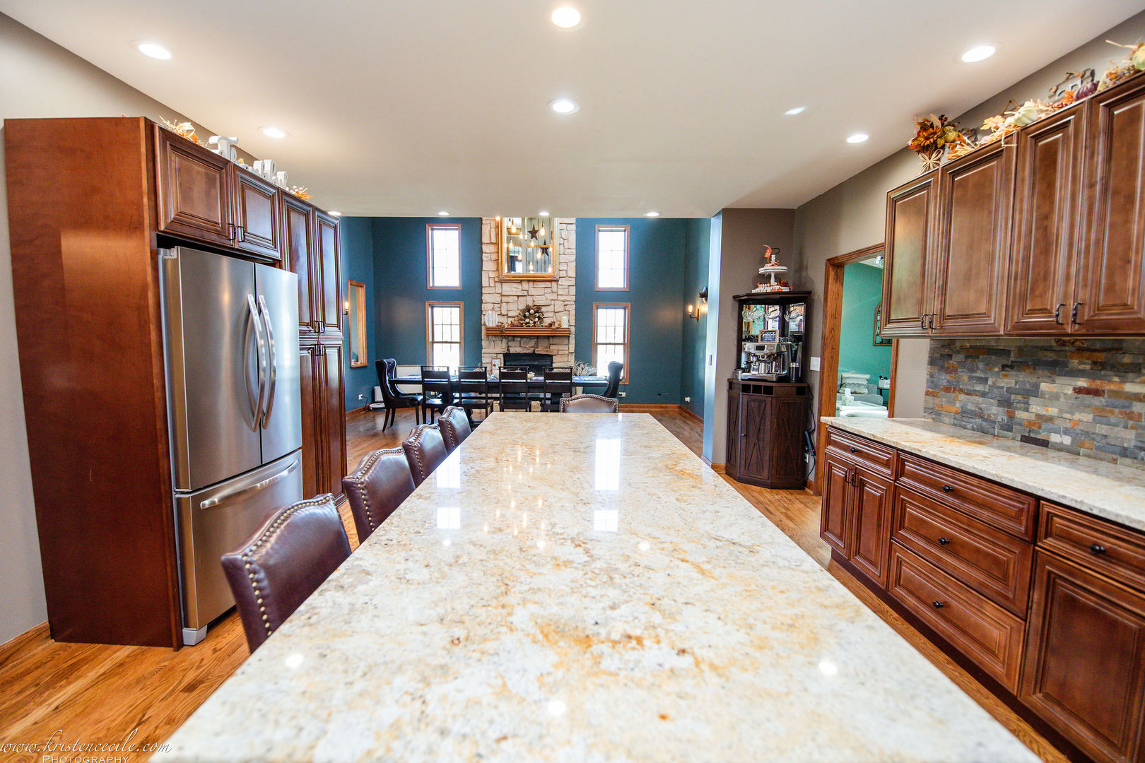 27243 South 88th Avenue Monee, IL 60449 - Photo 28 of 59 a large kitchen with stainless steel appliances kitchen island granite countertop a refrigerator and wooden cabinets