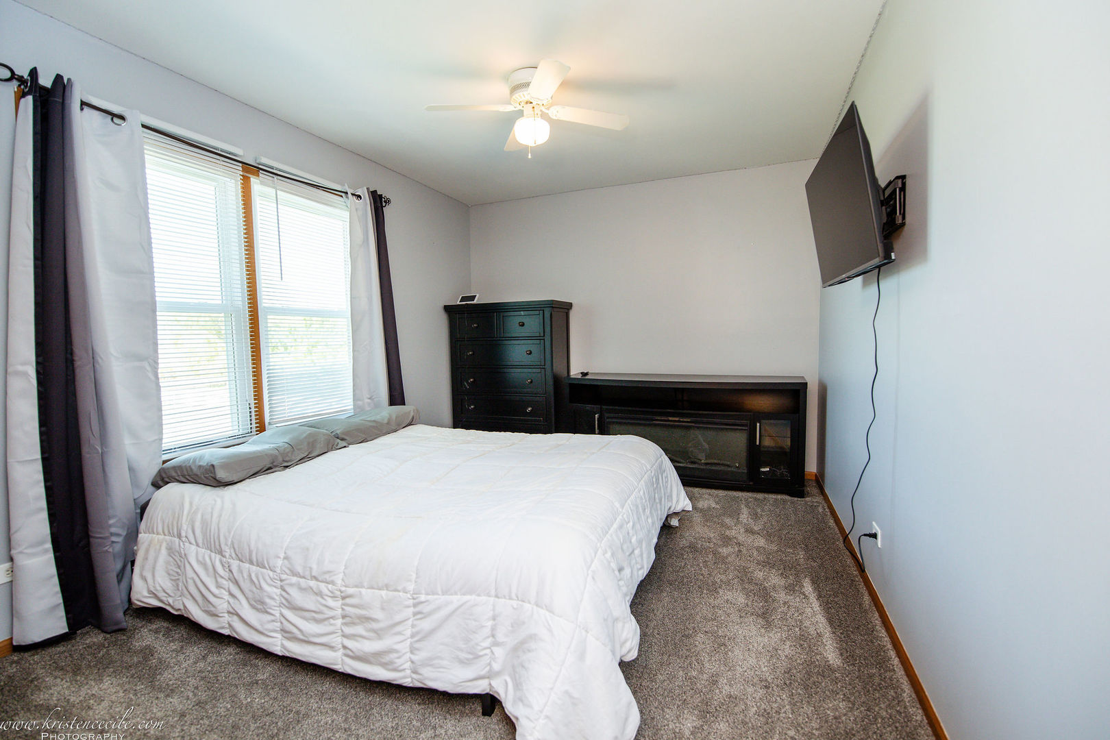 27243 South 88th Avenue Monee, IL 60449 - Photo 44 of 59 a bedroom with a bed and a flat tv screen on a dresser