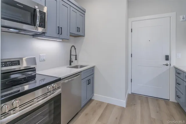 a kitchen with cabinets and steel stainless steel appliances