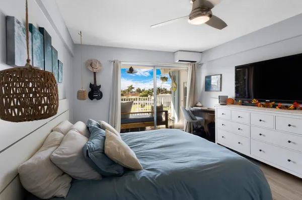 a bedroom with a bed and a large window