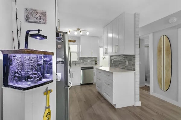a kitchen with a refrigerator and a stove top oven