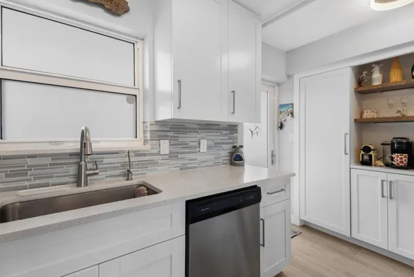 a kitchen with a sink and a refrigerator
