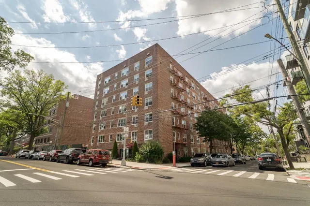 a view of a building and car parked on the side of road