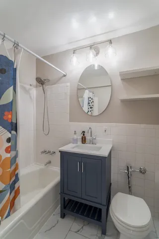 a bathroom with a sink a toilet and bathtub