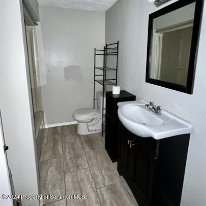 109 Smith Street Dupont, PA 18641 - Photo 3 of 8 a bathroom with a sink toilet and mirror