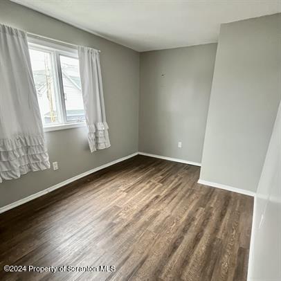 109 Smith Street Dupont, PA 18641 - Photo 5 of 8 an empty room with wooden floor and windows