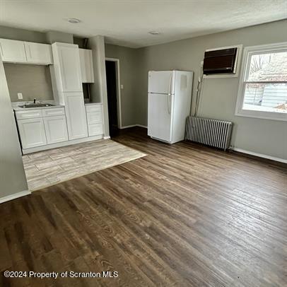 109 Smith Street Dupont, PA 18641 - Photo 6 of 8 a view of a kitchen with wooden floor and electronic appliances