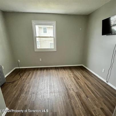 109 Smith Street Dupont, PA 18641 - Photo 7 of 8 an empty room with wooden floor and windows