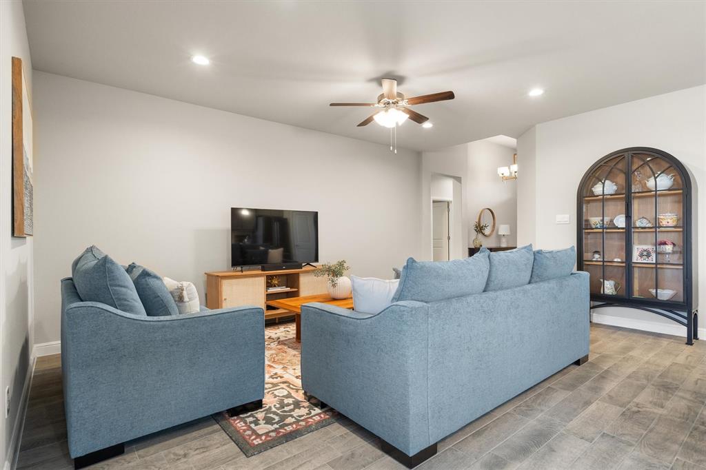 1864 Mensa Drive Haslet, TX 76052 - Photo 12 of 40 a living room with furniture and a flat screen tv