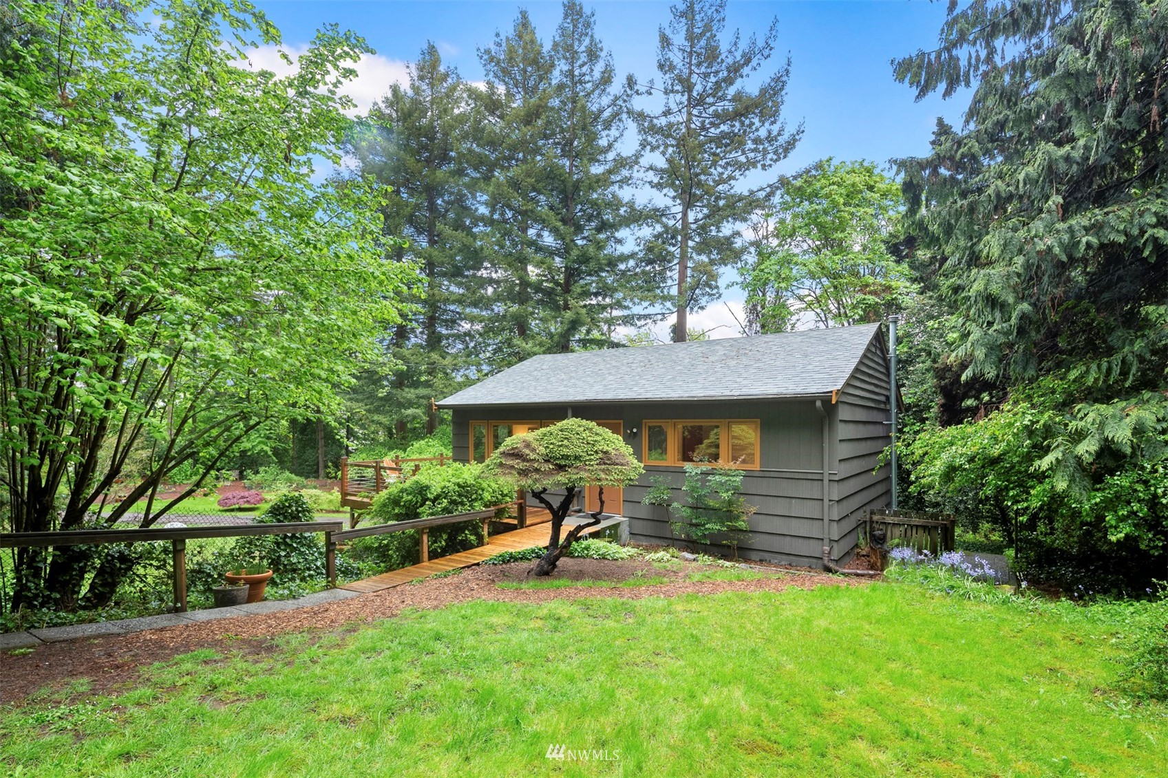 3715 South Webster Street Seattle, WA 98118 - Photo 2 of 39 a view of a backyard with table and chairs under an umbrella
