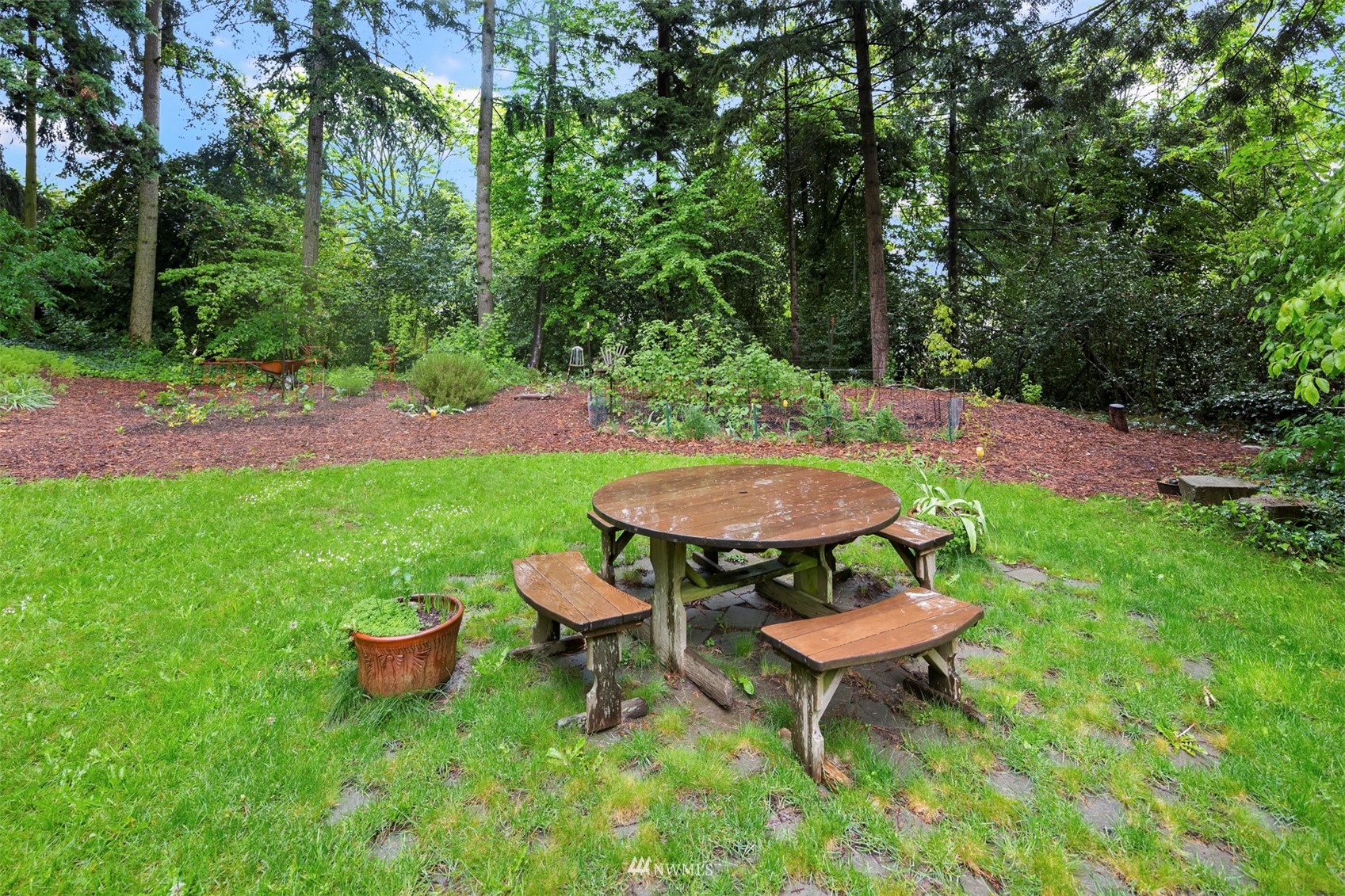 3715 South Webster Street Seattle, WA 98118 - Photo 31 of 39 a view of a backyard with table and chairs with wooden fence