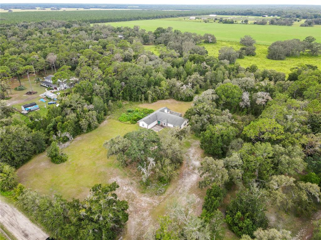 18321 McMullen Road Spring Hill, FL 34610 - Photo 12 of 56 an aerial view of residential houses with outdoor space and trees
