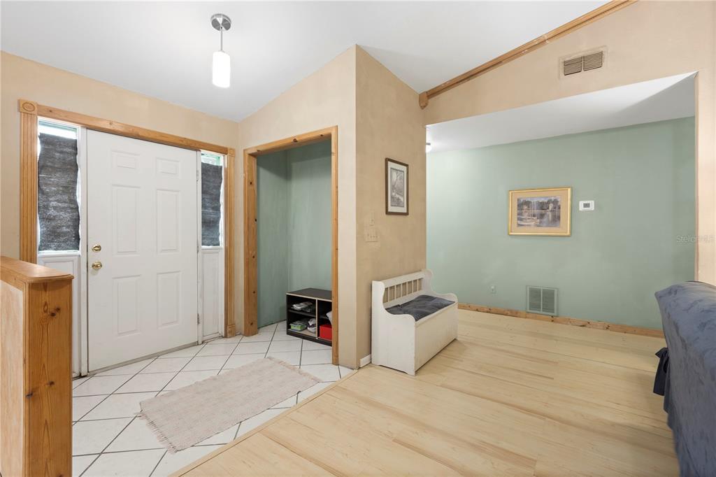 18321 McMullen Road Spring Hill, FL 34610 - Photo 15 of 56 a bedroom with a bed and a chandelier