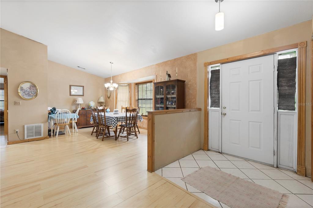 18321 McMullen Road Spring Hill, FL 34610 - Photo 16 of 56 a living room with furniture a dining table and kitchen view
