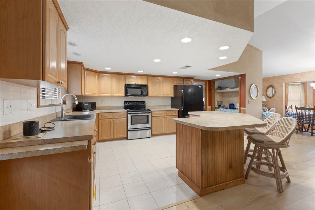 18321 McMullen Road Spring Hill, FL 34610 - Photo 20 of 56 a kitchen with stainless steel appliances granite countertop a sink counter space and cabinets
