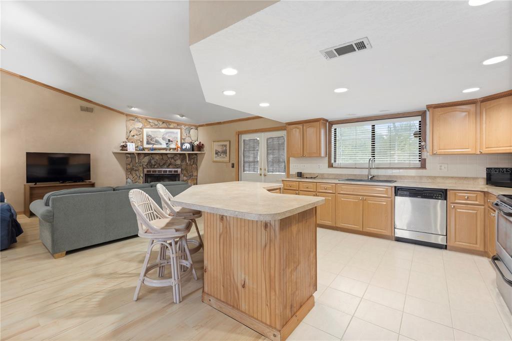 18321 McMullen Road Spring Hill, FL 34610 - Photo 22 of 56 a kitchen with a sink a counter top space stainless steel appliances and cabinets
