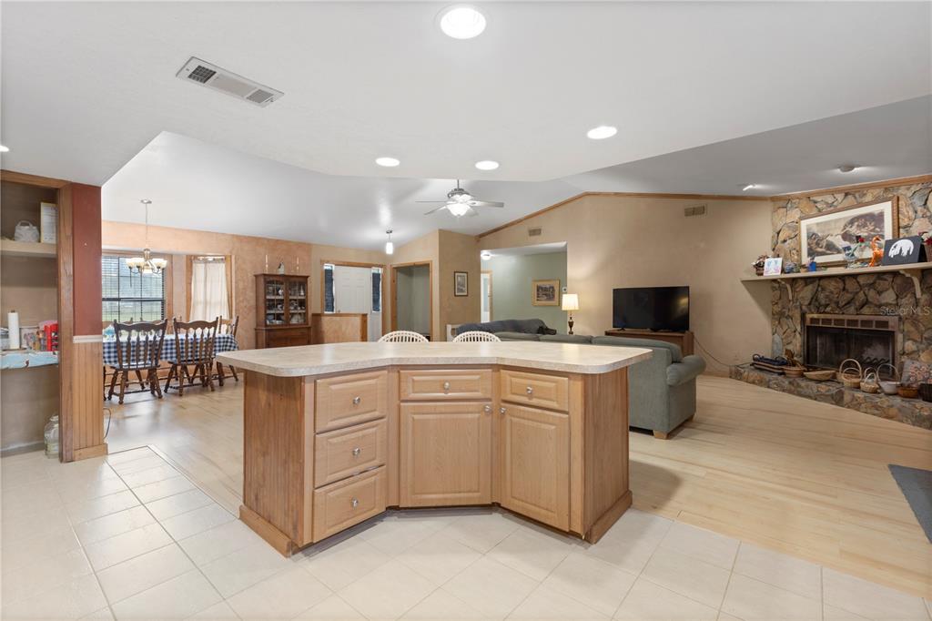 18321 McMullen Road Spring Hill, FL 34610 - Photo 25 of 56 a large kitchen with a large counter top appliances and cabinets