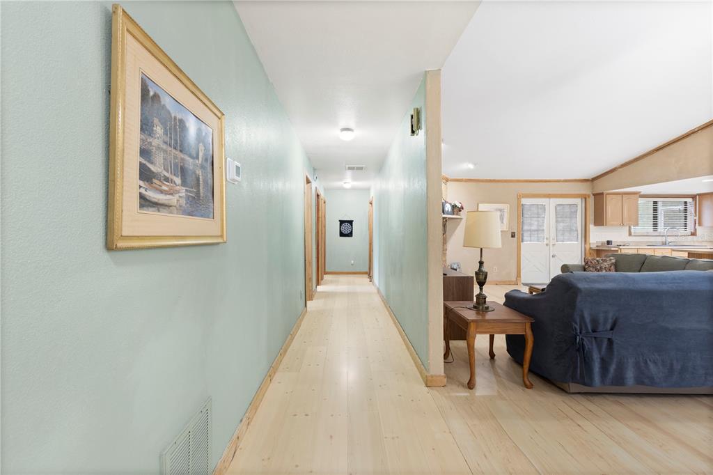 18321 McMullen Road Spring Hill, FL 34610 - Photo 29 of 56 a view of a hallway with furniture and wooden floor