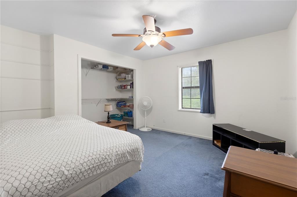 18321 McMullen Road Spring Hill, FL 34610 - Photo 30 of 56 a bedroom with a bed and a window