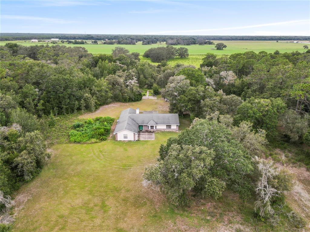 18321 McMullen Road Spring Hill, FL 34610 - Photo 3 of 56 an aerial view of residential houses with outdoor space and trees
