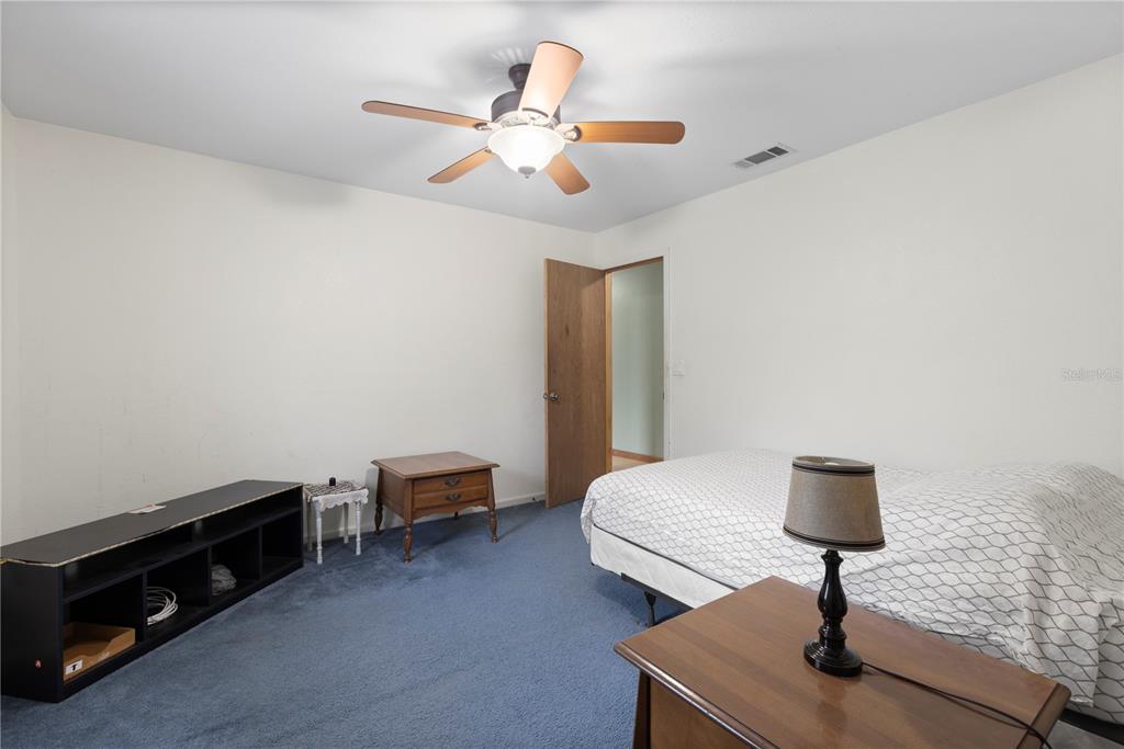 18321 McMullen Road Spring Hill, FL 34610 - Photo 31 of 56 a living room with furniture and a lamp