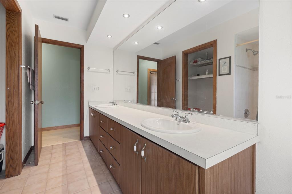 18321 McMullen Road Spring Hill, FL 34610 - Photo 34 of 56 a bathroom with a sink double vanity and a mirror