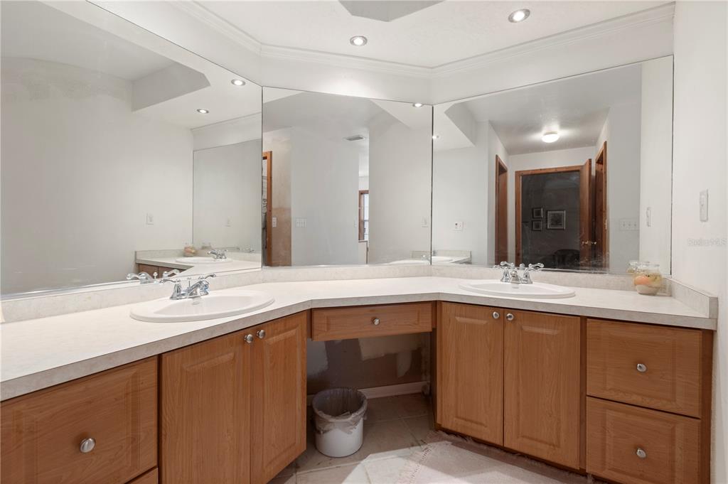 18321 McMullen Road Spring Hill, FL 34610 - Photo 40 of 56 a bathroom with a sink double vanity granite and a mirror