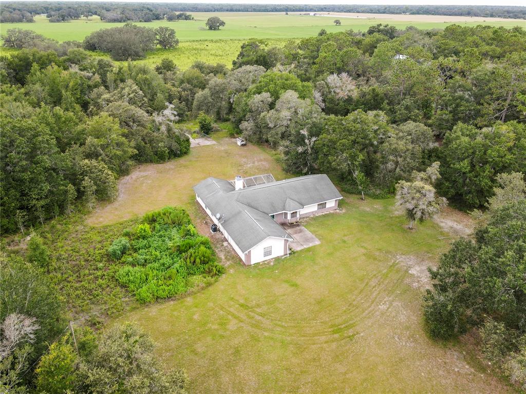18321 McMullen Road Spring Hill, FL 34610 - Photo 4 of 56 an aerial view of residential houses with outdoor space and trees